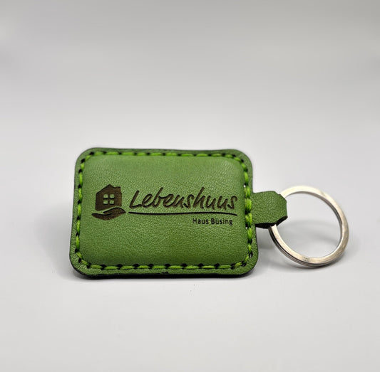 Grüner NFC-Schlüsselanhänger aus Leder mit eingraviertem Logo „Lebenshaus Haus Büsing“ – nachhaltiges Design von EngelzKind.
